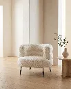 Generated with Kive.ai - White bouclé armchair A high-end Mediterranean contemporary interior featuring a premium designer armchair as the main focal point. The composition is minimalist_ editorial_ and inspire (1).webp