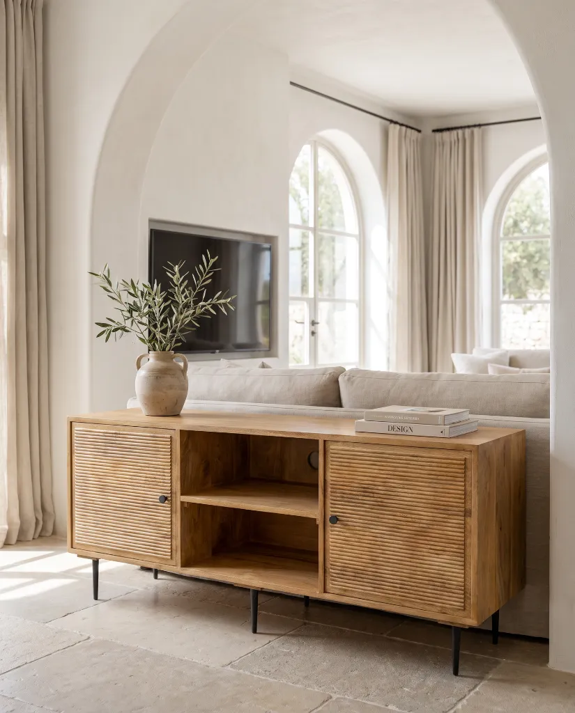 Generated with Kive.ai - Luxury interior photography of a handcrafted TV cabinet made entirely of solid natural mango wood as the absolute focal point of a sophisticated Mediterranean-inspired living room. The  (4).webp